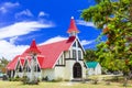 Traditional Red Church and flamboyant tree in Cap Malheureux,Mauritius island. Royalty Free Stock Photo