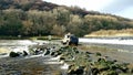 Landrover 4x4 OffRoading across lopwell Dam .Devon