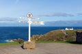 Lands End Cornwall England UK signpost blue sea and sky