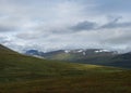 Landscap of Lapland nature at Kungsleden hiking trail with colorful mountains, rocks, autumn colored bushes, birch tree and heath