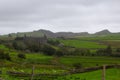 Landscape across the green fields of the welsh countryside with the old slate mill