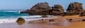 Landscape of Adraga sandy beach with stones near Sintra, Portugal rocky coast