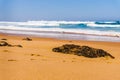 Landscape of Adraga sandy beach with stones, Portugal coast of Atlantic ocean