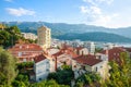 Landscape aerial view on roofs of old historical town of Budva and sea bay, mountains and forests of Montenegro, on background of Royalty Free Stock Photo