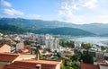 Landscape aerial view on roofs of old historical town of Budva and sea bay, mountains and forests of Montenegro, on background of Royalty Free Stock Photo