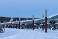 Landscape of the Alaskan oil pipeline on icy ground and snowy trees in Fairbanks, Alaska Royalty Free Stock Photo