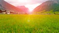 Landscape Alpine green fields and traditional wooden houses view of the village at spring with sunshine. Location, Alps. Europe Royalty Free Stock Photo