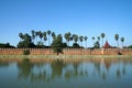 Landscape Ancient brown brick Palace wall with sugar palm tree and Moat surrounding of Mandalay palace located in Mandalay, Burma