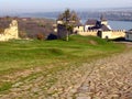 Ancient road paved with cobblestone and going to medieval fortress in Khotyn on hill above river. Royalty Free Stock Photo