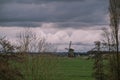 Landscape with ancient windmills in the Netherlands in gloomy spring weather. Stormy day over Dutch village of Streefkerk Royalty Free Stock Photo