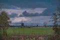 Landscape with ancient windmills in the Netherlands in gloomy spring weather. Stormy day over Dutch village of Streefkerk Royalty Free Stock Photo