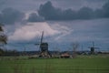 Landscape with ancient windmills in the Netherlands in gloomy spring weather. Stormy day over Dutch village of Streefkerk Royalty Free Stock Photo