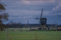 Landscape with ancient windmills in the Netherlands in gloomy spring weather. Stormy day over Dutch village of Streefkerk Royalty Free Stock Photo