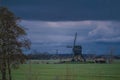 Landscape with ancient windmills in the Netherlands in gloomy spring weather. Stormy day over Dutch village of Streefkerk Royalty Free Stock Photo