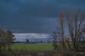 Landscape with ancient windmills in the Netherlands in gloomy spring weather. Stormy day over Dutch village of Streefkerk Royalty Free Stock Photo