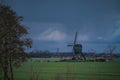 Landscape with ancient windmills in the Netherlands in gloomy spring weather. Stormy day over Dutch village of Streefkerk Royalty Free Stock Photo