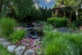 Landscape architecture with water feature and ornamental grass and gazebo Royalty Free Stock Photo