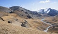 Landscape in the Asian mountains with three riders on horseback Royalty Free Stock Photo