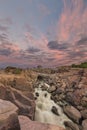 Landscape of the Augrabies Waterfall at sunset and pink clouds