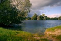 landscape in autumn, dark clouds and golden sun over a small lake in Klein Schneen, Friedland,