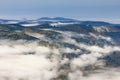 Landscape in autumn mountains. View from the top of the mountain on the forest fog coatings. Royalty Free Stock Photo