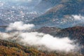 Landscape in autumn mountains. View from the top of the mountain on the forest fog coatings. Royalty Free Stock Photo