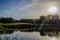 Landscape with autumn park in the sunny day. Yellow and green trees are displayed with reflection on the lake. Royalty Free Stock Photo