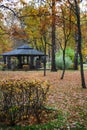 Landscape In The Autumn Park. Wooden Gazebo For Relaxing Among Yellow Foliage And Autumn Trees. Wooden Gazebo On The