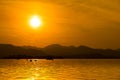 The landscape Background of a golden sunset reflect water and silhouette mountain in west lake xihu in Hangzhou CHINA Royalty Free Stock Photo