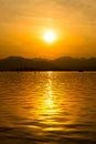 The landscape Background of a golden sunset reflect water and silhouette mountain in west lake xihu in Hangzhou CHINA Royalty Free Stock Photo