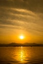 The landscape Background of a golden sunset reflect water and silhouette mountain in west lake xihu in Hangzhou CHINA - Image Royalty Free Stock Photo