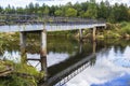 Landscape background old rusty iron bridge over a river forest Royalty Free Stock Photo