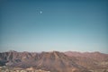 Landscape of bald mountains under the blue evening sky with the moon Royalty Free Stock Photo