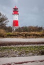 Landscape baltic sea dunes lighthouse in red and white