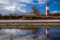 Landscape baltic sea dunes lighthouse in red and white