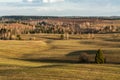 Long shadows from the setting sun on hilly fields in early spring Royalty Free Stock Photo