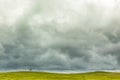 Moody cloudy sky with a barren field