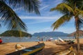 Landscape with the beach of Brazil on the island of Ilha Grande. Fishing boats and people in a paradise of the Atlantic Ocean Royalty Free Stock Photo