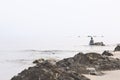 Landscape of beach and sea which has fisherman was fishing with net and cloudy sky in morning Royalty Free Stock Photo