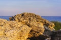 Landscape beach with stones, grass, sea, blue sky