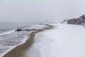 Landscape of the beach in winter time. white fluffy snow instead of yellow fine sand. Royalty Free Stock Photo