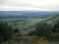 Landscape with beautiful evening mist over forest covered hills Royalty Free Stock Photo