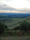 Landscape with beautiful evening mist over forest covered hills Royalty Free Stock Photo