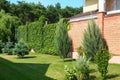 Landscape with beautiful green garden near  house on sunny day Royalty Free Stock Photo