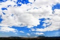 Landscape of beautiful green mountain view with wide blue sky and white clouds Royalty Free Stock Photo