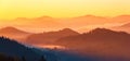 Landscape with beautiful mountains, fields and forests covered with morning fog. Panorama with interesting sunrise. Autumn.