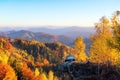 Landscape with beautiful mountains, fields and forests. The lawn is enlightened by the sun rays. Fantastic autumn morning.