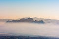 Landscape beautiful nature forest mountains and small town valley in fog Royalty Free Stock Photo