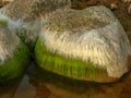 Beautiful rocks by the sea, colorful reflections in the water Royalty Free Stock Photo