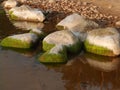 Beautiful rocks by the sea, colorful reflections in the water Royalty Free Stock Photo